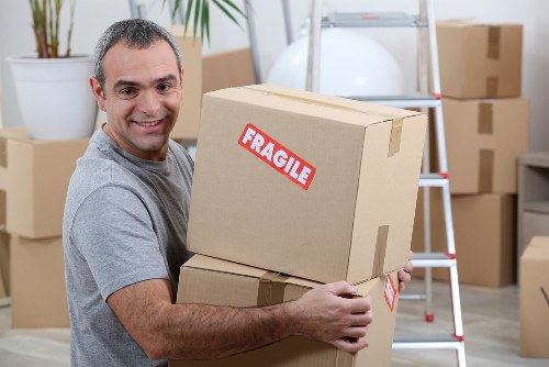 Team preparing a safe moving operation with boxes and van